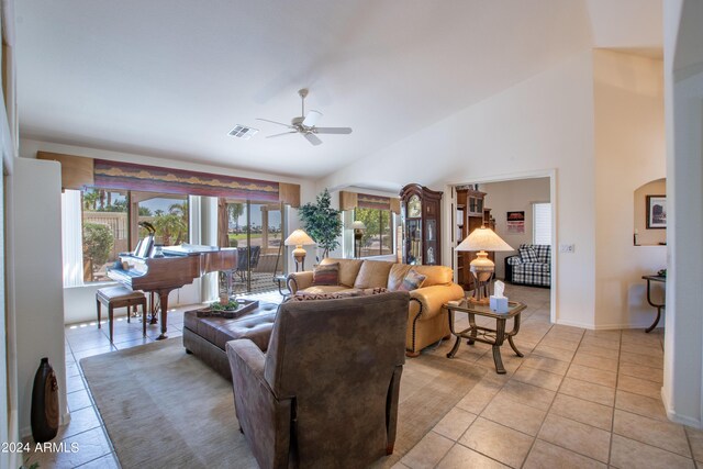 living area featuring lofted ceiling and light tile patterned floors