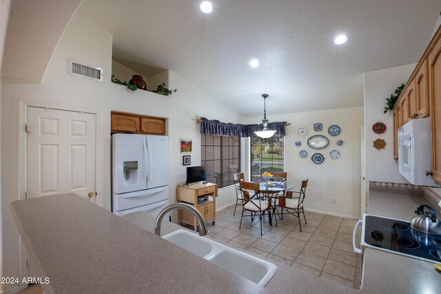 tiled foyer entrance with vaulted ceiling