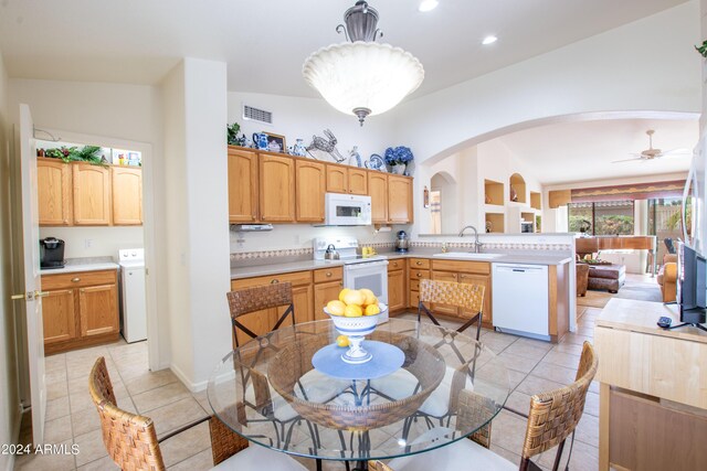 living room featuring built in features, ceiling fan, light tile patterned floors, and high vaulted ceiling