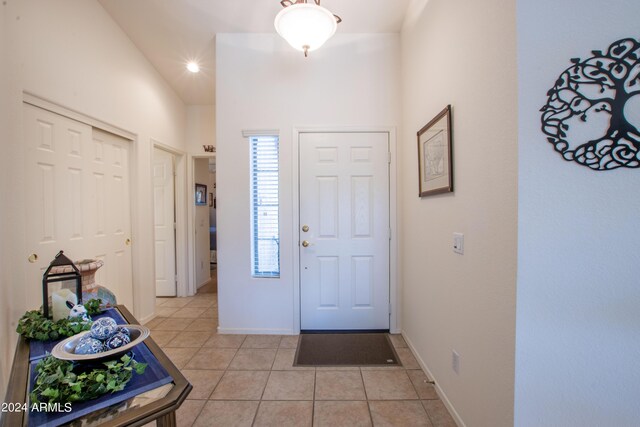 misc room with vaulted ceiling and light colored carpet