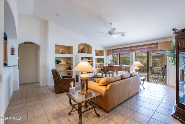 tiled living room featuring lofted ceiling and ceiling fan