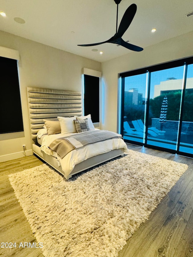 bedroom with access to outside, wood-type flooring, and ceiling fan