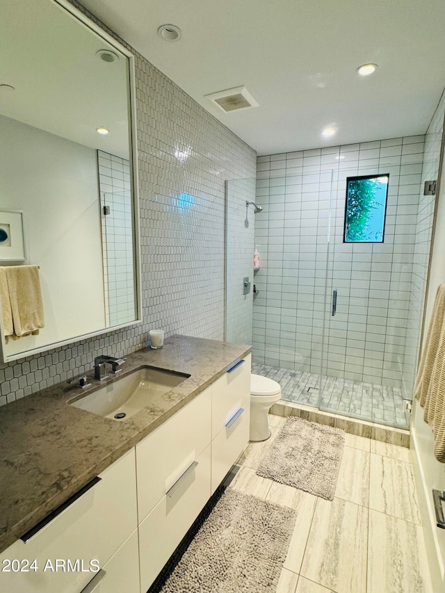 bathroom featuring walk in shower, toilet, wood-type flooring, tasteful backsplash, and vanity