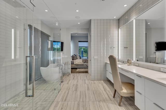 bathroom with vanity, tile walls, and separate shower and tub