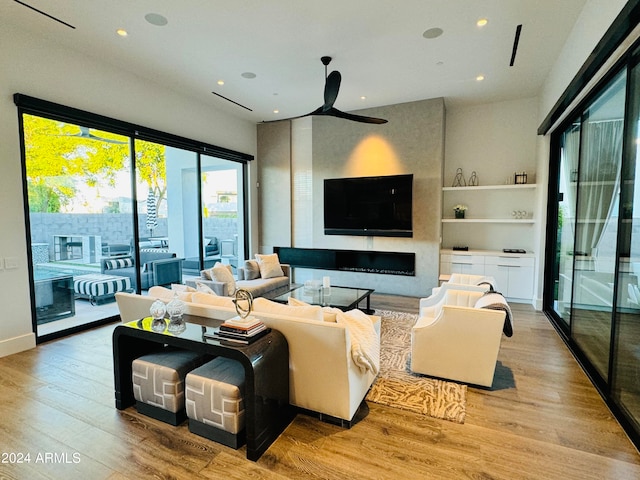 living room with hardwood / wood-style floors and ceiling fan