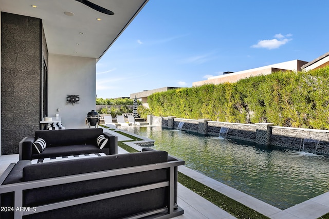 balcony featuring grilling area and pool water feature