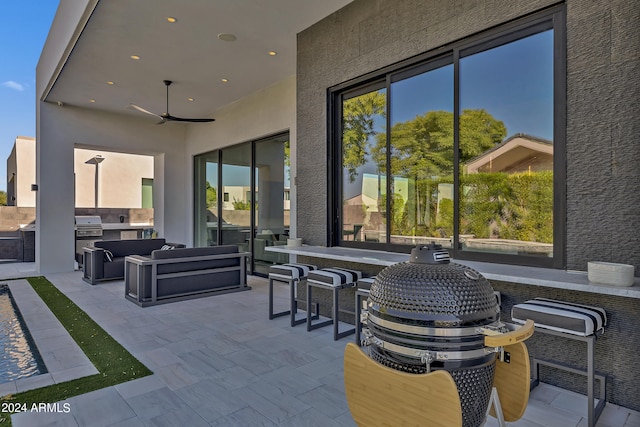 view of patio featuring exterior kitchen and ceiling fan