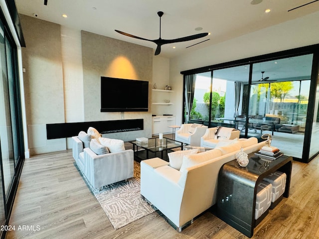 living room with hardwood / wood-style floors and ceiling fan