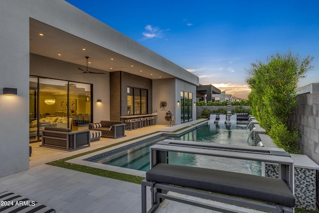 pool at dusk with a patio