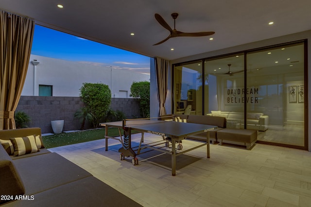 patio terrace at dusk featuring ceiling fan