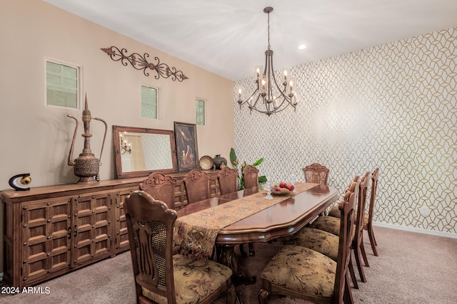 carpeted dining area featuring a chandelier