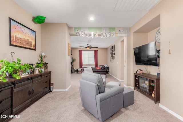 living room featuring ceiling fan and light colored carpet