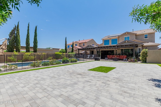 exterior space with an outdoor living space, a pergola, and a swimming pool