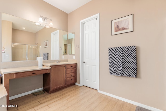 bathroom with vanity, wood-type flooring, and walk in shower