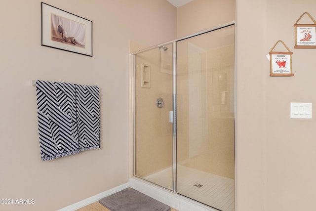 bathroom with tile patterned floors and walk in shower