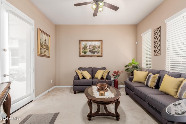 carpeted living room featuring ceiling fan