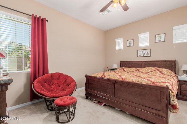 bedroom featuring light colored carpet and ceiling fan