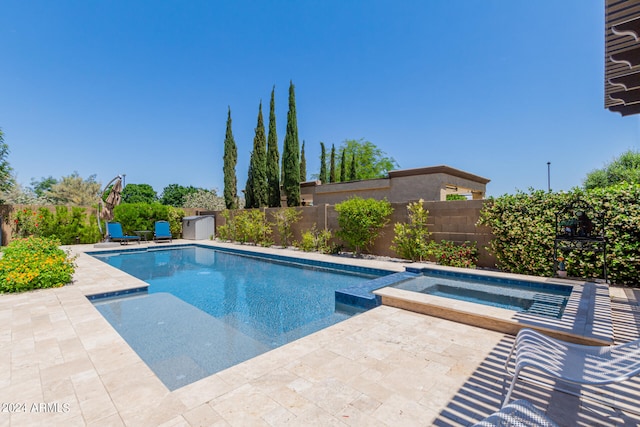 view of swimming pool with an in ground hot tub