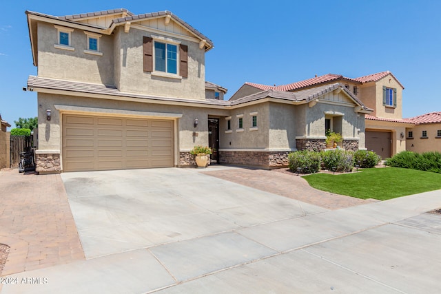 view of front of property with a garage and a front lawn