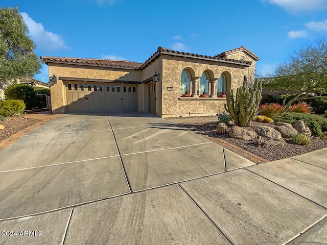 mediterranean / spanish house featuring a garage