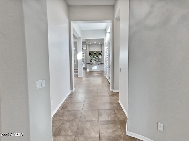 hall featuring light tile patterned flooring