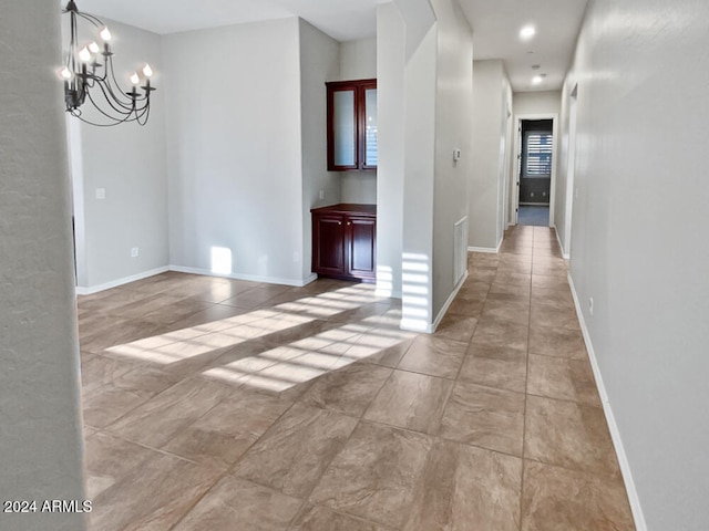 hallway featuring an inviting chandelier