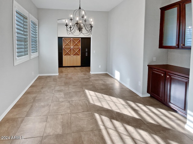 unfurnished dining area with a notable chandelier and a wealth of natural light