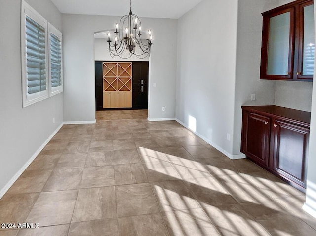 12446 W Bajada Rd, Peoria, AZ 85383 - unfurnished dining area featuring a chandelier and baseboards