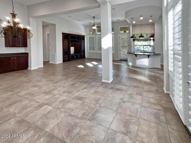 12446 W Bajada Rd, Peoria, AZ 85383 - unfurnished living room with ceiling fan, a chandelier, and baseboards