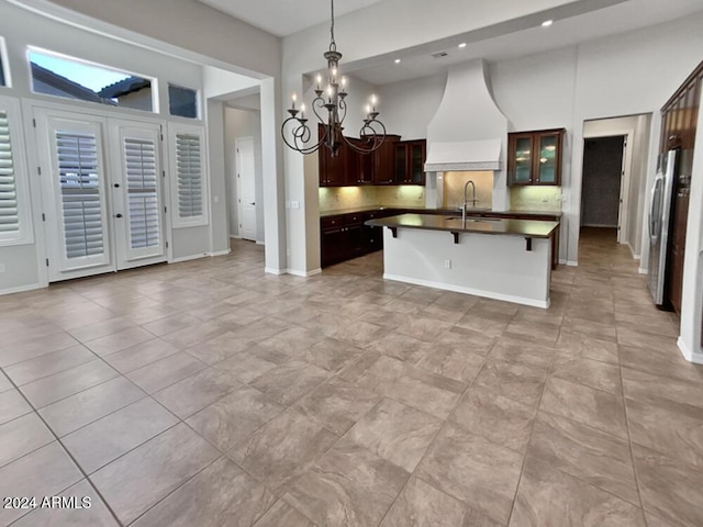 12446 W Bajada Rd, Peoria, AZ 85383 - kitchen with premium range hood, a sink, a chandelier, dark countertops, and freestanding refrigerator