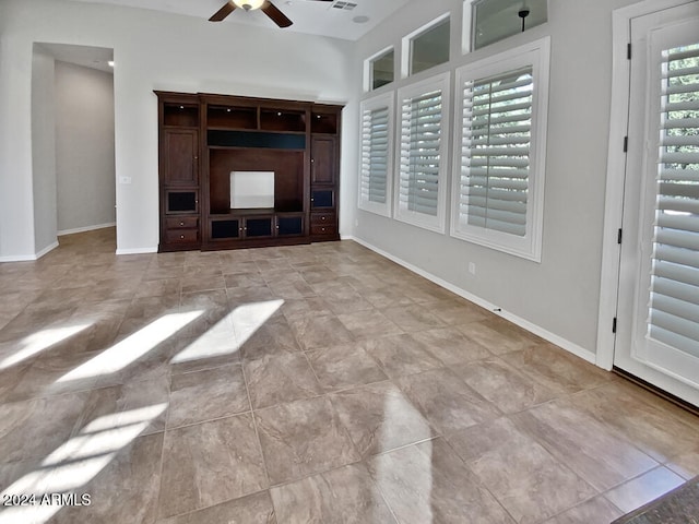 unfurnished living room with ceiling fan