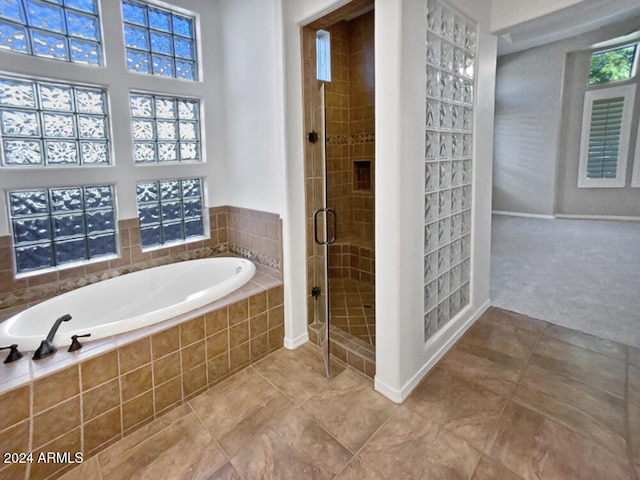 bathroom with tile patterned floors and plus walk in shower