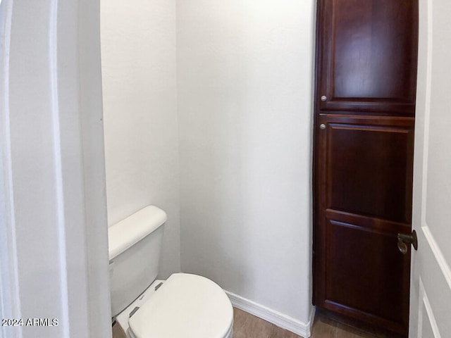 bathroom featuring hardwood / wood-style floors and toilet