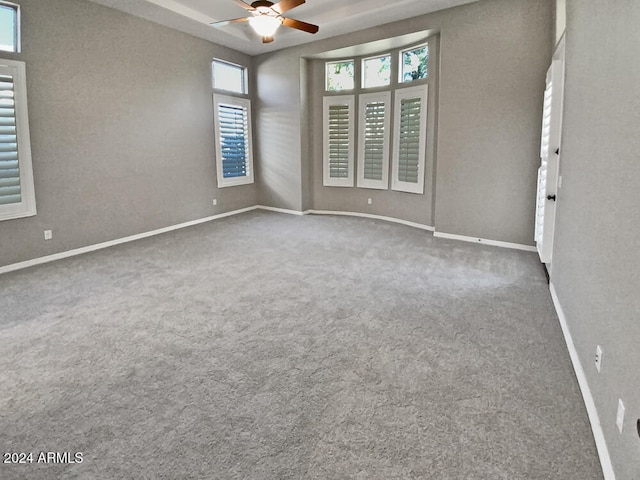 empty room featuring carpet flooring and ceiling fan