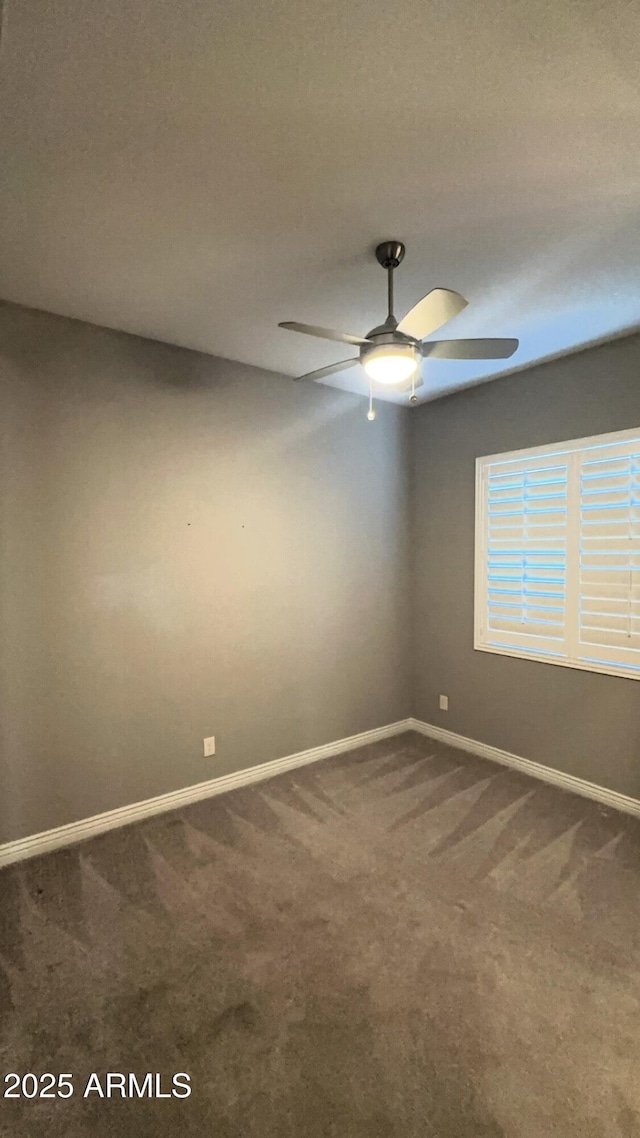 empty room featuring carpet flooring and ceiling fan