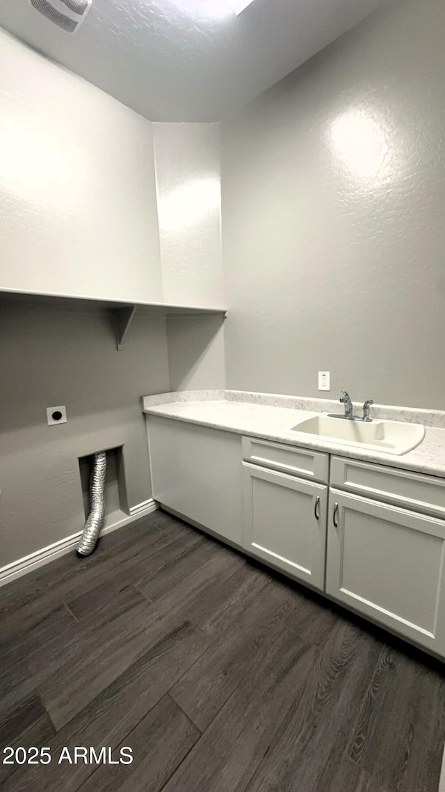 laundry area with sink, cabinets, dark hardwood / wood-style floors, and hookup for an electric dryer