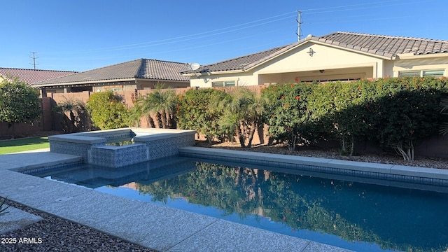 view of swimming pool with a jacuzzi