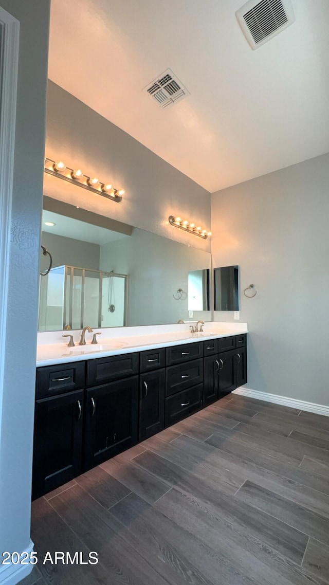 bathroom featuring vanity and an enclosed shower