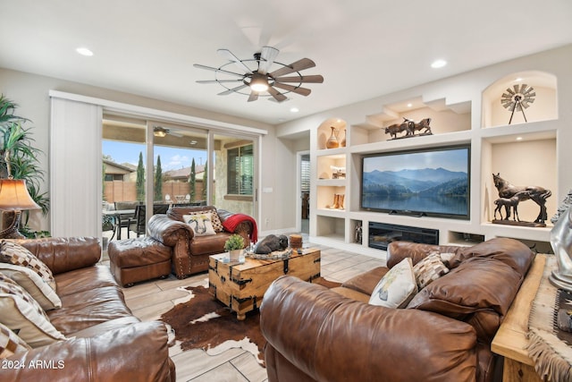 living room with ceiling fan and built in features