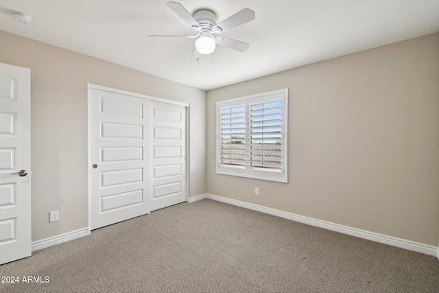 unfurnished bedroom with carpet flooring, a closet, and ceiling fan