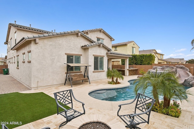 view of swimming pool featuring a patio and an outdoor bar