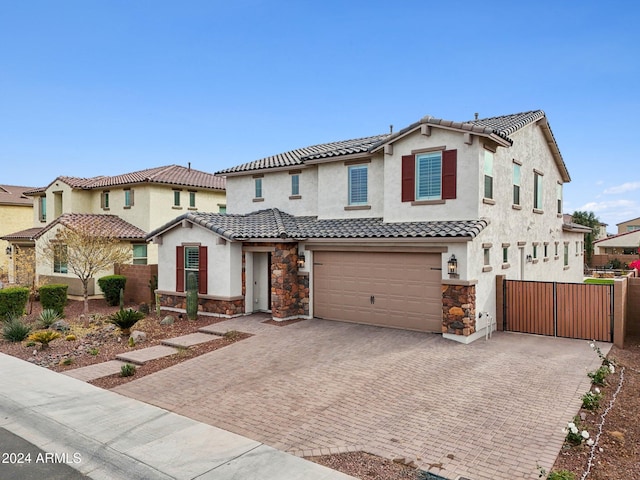 mediterranean / spanish home featuring a garage