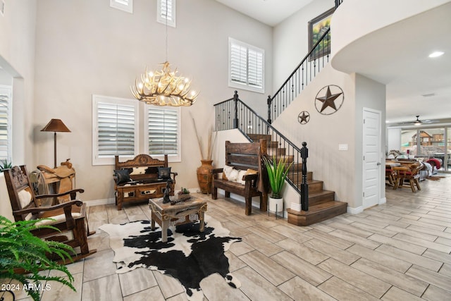 entrance foyer featuring a towering ceiling and an inviting chandelier