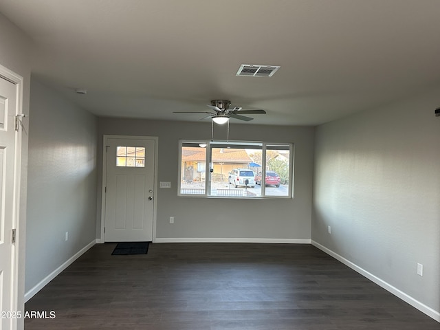 interior space with ceiling fan and dark hardwood / wood-style flooring