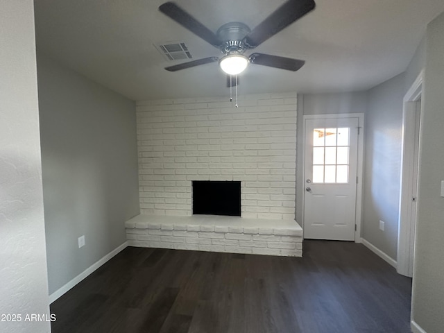 unfurnished living room featuring ceiling fan, a fireplace, and dark hardwood / wood-style flooring