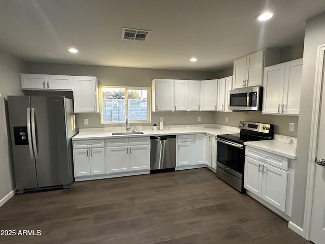 kitchen with sink, stainless steel appliances, dark hardwood / wood-style floors, and white cabinets