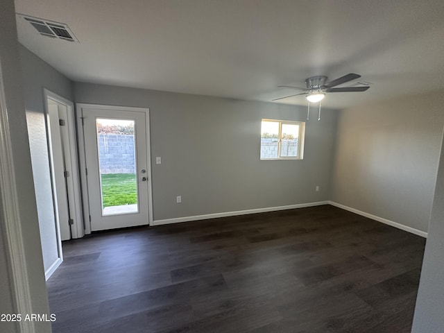 spare room with dark hardwood / wood-style floors and ceiling fan