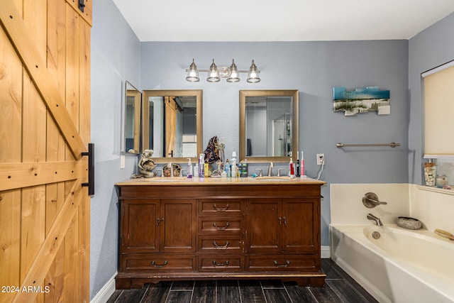 bathroom featuring a bathtub, vanity, and wood-type flooring