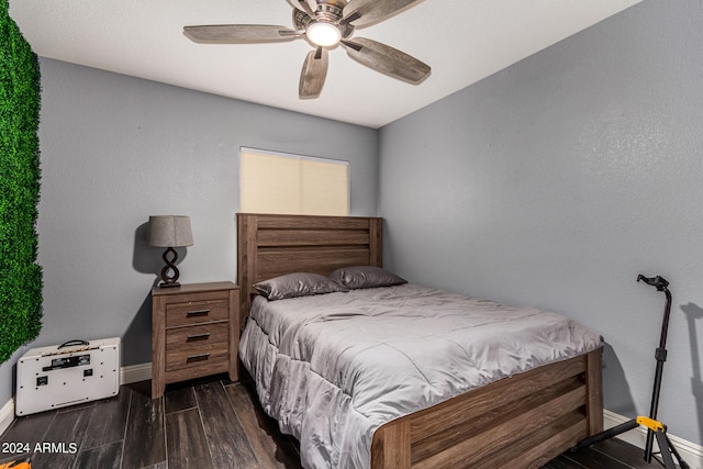 bedroom with ceiling fan and dark hardwood / wood-style floors