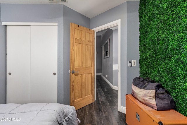 bedroom featuring a closet and dark hardwood / wood-style flooring